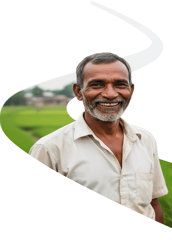 A farmer standing in a paddy field in rural Bangladesh